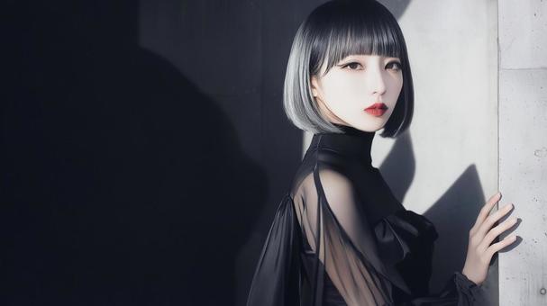 黒いドレスを着たボブヘアーの魅惑的な女性の写真