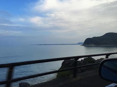車窓から望む穏やかな海岸線の風景 車窓から望む穏やかな海岸線の風景の写真