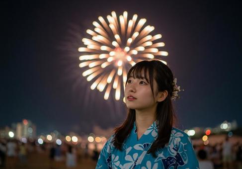 花火を楽しむ浴衣の女性 花火を楽しむ浴衣の女性の写真