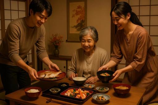 お祝い料理を配膳する家族 お祝い料理を配膳する家族の写真