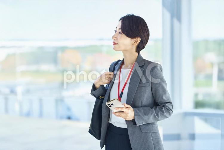 スマホを持つ歩く女性　仕事　ビジネス ビジネスウーマン,スマホ,通勤の写真素材