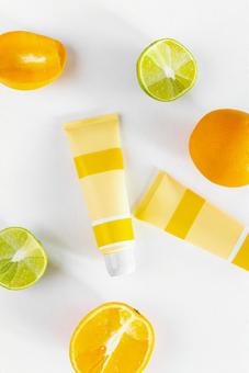 Fruit cross section and two yellow tubes (white background), JPG