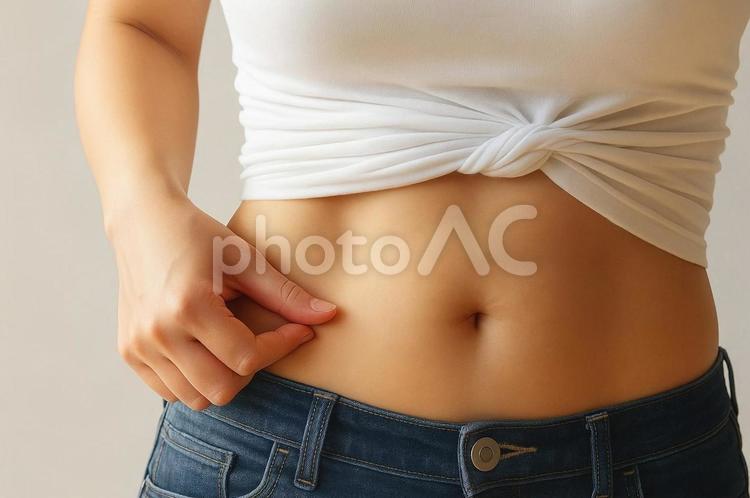 お腹の脂肪をつまむ女性・ダイエット・美容 お腹の脂肪,ダイエット,体型チェックの写真素材