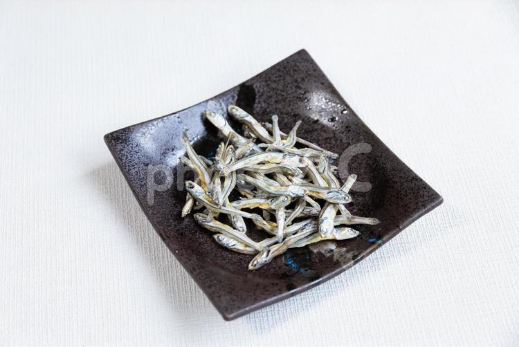 黒の角皿に盛られた煮干し 煮干し,魚,小魚の写真素材