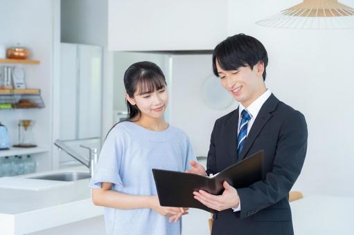 リビングで女性と商談をするビジネスマン リビングで女性と商談をするビジネスマン 営業,不動産,女性の写真素材