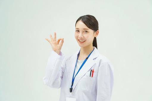 A woman in a white coat signing OK, JPG A woman in a white coat signing OK, a doctor, doctor, hospital, JPG