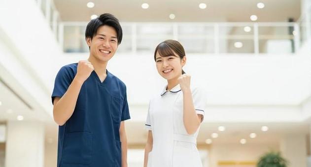 笑顔でガッツポーズをするアジア人看護師 笑顔でガッツポーズをするアジア人看護師の写真