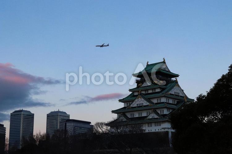 夕暮れの大阪城と飛行機 大阪城,飛行機,夕暮れの写真素材