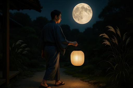 提灯を持って庭に出る男性と満月 提灯を持って庭に出る男性と満月の写真