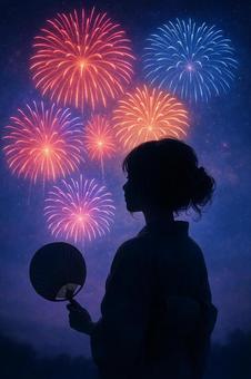 浴衣姿の女性と夏の夜空に広がる花火 浴衣姿の女性と夏の夜空に広がる花火の写真