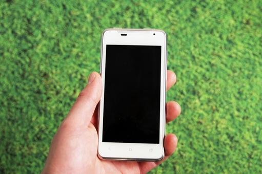 スマホを手に持つ スマホを手に持つ スマートフォン,携帯電話,手の写真素材