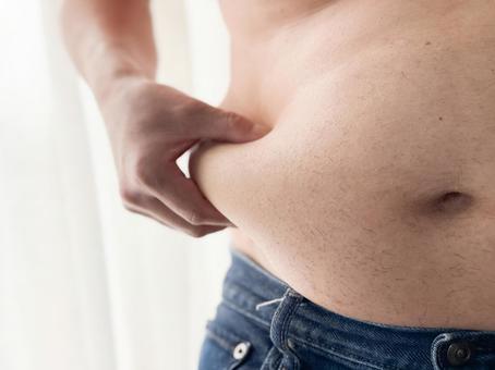 お腹の贅肉をつまむメタボ男性 肥満,メタボ,男性の写真素材