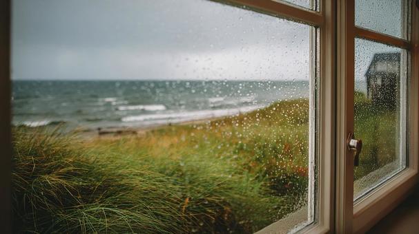 窓辺から見る波立つ海岸の写真