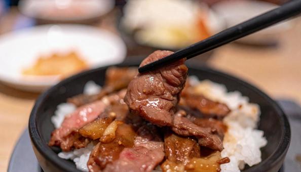 焼き肉を白ご飯に着けて食べる 焼き肉を白ご飯に着けて食べるの写真