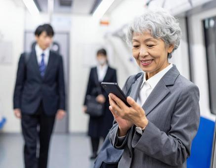 ビジネスシーン・地下鉄出張、スマホを見る ビジネスシーン・地下鉄出張、スマホを見るの写真
