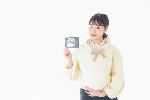 エコー画像を持つ若い妊婦の女性 エコー画像を持つ若い妊婦の女性 ヘルスケア,教育,看護師の写真素材