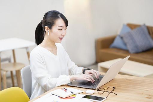 A woman working in a casual space, female, telework, pc, JPG