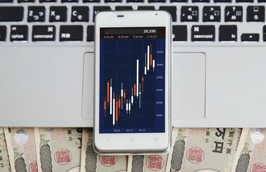 スマホと株価チャートと日本円 スマートフォン,株価,チャートの写真素材