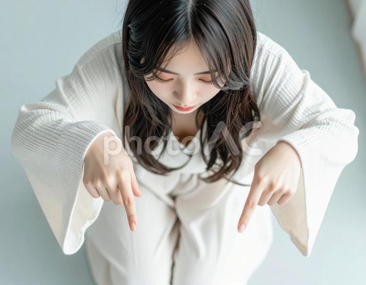 下を指差す女性 指差し,案内,注目の写真素材
