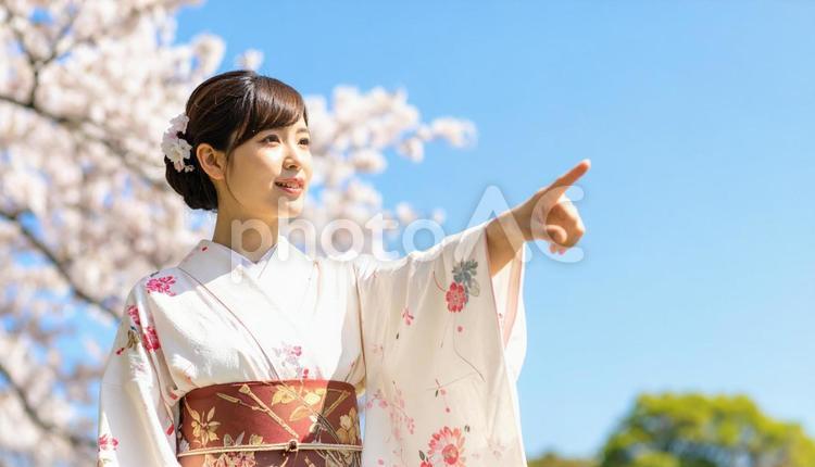 指を指す着物を着た女性と青空 着物,女性,青空の写真素材