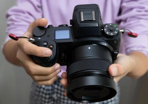 カメラを操作する女性の手元 カメラ,ミラーレス一眼,デジタルカメラの写真素材