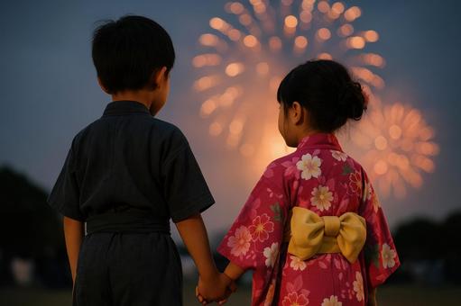 花火を見つめる兄妹の後ろ姿 花火を見つめる兄妹の後ろ姿の写真