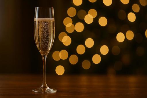 シャンパングラスと灯の写真