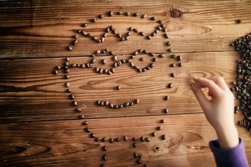 コーヒー豆で描いた顔 コーヒー豆で描いた顔の写真