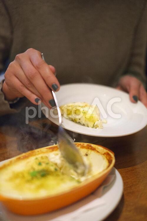 料理を取り分ける仕草 グラタン,グラタン皿,取り分けるの写真素材