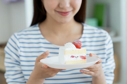 ケーキを食べる若い女性 ケーキを食べる若い女性 ケーキ,女性,スイーツの写真素材