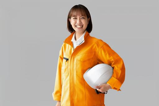 ヘルメットを持った笑顔の女性 アルバイト,求人,パートの写真素材