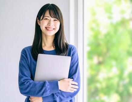 ノートパソコンを持つ女性1の写真