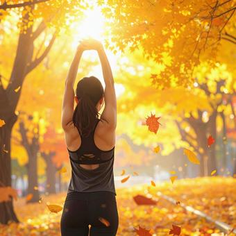 スポーツの秋 紅葉の中でストレッチ 女性 スポーツの秋 紅葉の中でストレッチ 女性の写真