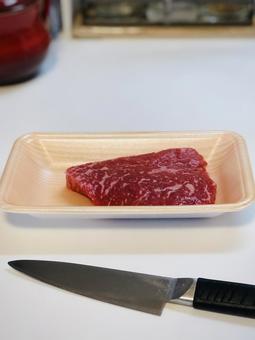 牛ステーキ用国産モモ肉と包丁 牛ステーキ用国産モモ肉と包丁の写真