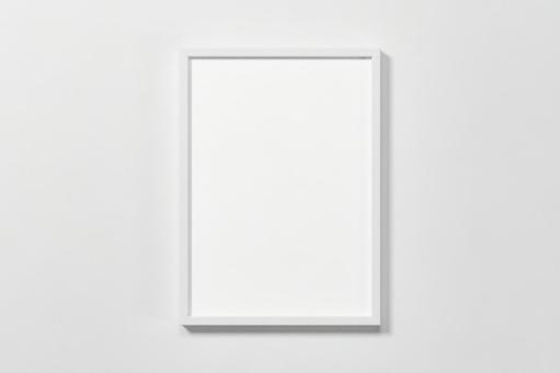 White wall. White vertical A4 and A3 size picture frames. White wall. White vertical A4 and A3 size picture frames.