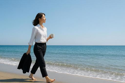 海辺で靴を脱ぎ波打ち際を歩くの写真