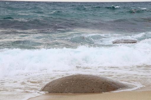 波にうたれそうな岩の写真