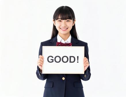 A female student holding a board that says "Good", girl, good, board, JPG