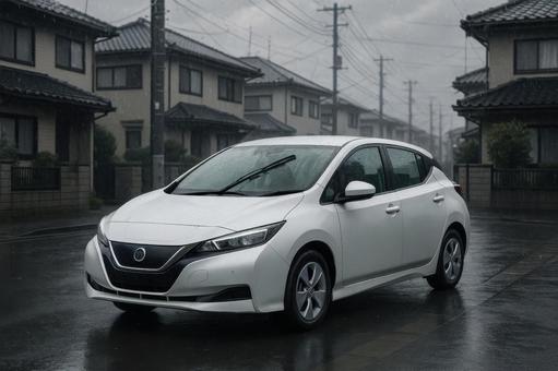 雨の住宅街を走行する電気自動車 雨の住宅街を走行する電気自動車の写真