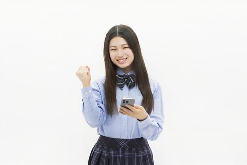女子高生 ガッツポーズ スマートフォン 女子高生 ガッツポーズ スマートフォン 女子高生,スマートフォン,中学生の写真素材