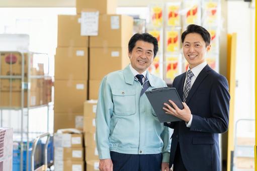 倉庫で商談をする経営者とビジネスマン 倉庫で商談をする経営者とビジネスマン 会議,倉庫,工場の写真素材