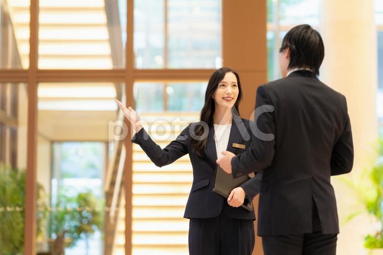 お客を案内するホテルマンの女性 フロント,ホテルマン,コンシェルジュの写真素材