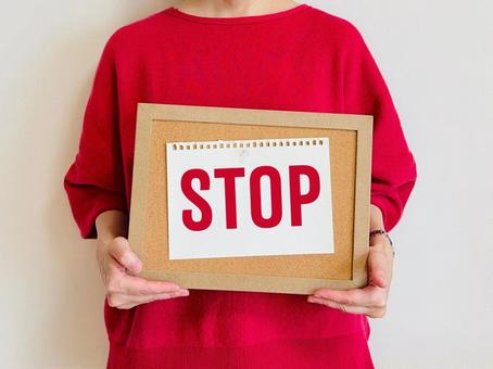 A woman holding a sign that says STOP, JPG