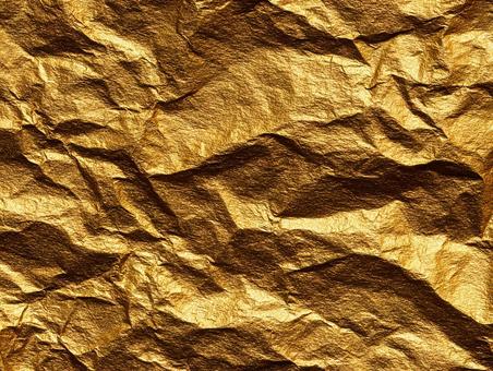 輝くしわのある金箔のテクスチャの写真