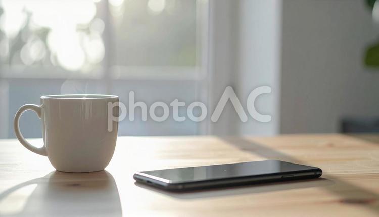 テーブルのコーヒーとスマホ テーブル,カップ,影の写真素材