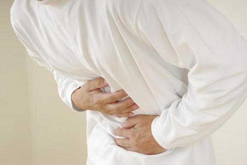 お腹の痛みに苦しむ中年男性 腹痛,胃痛,胃腸炎の写真素材