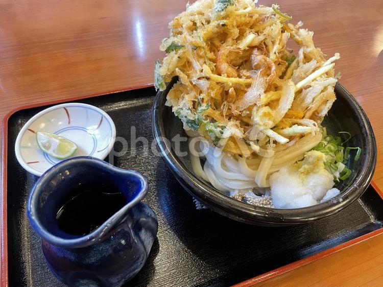 大きいかき揚げが乗ったぶっかけうどん うどん,冷たいうどん,天ぷらの写真素材