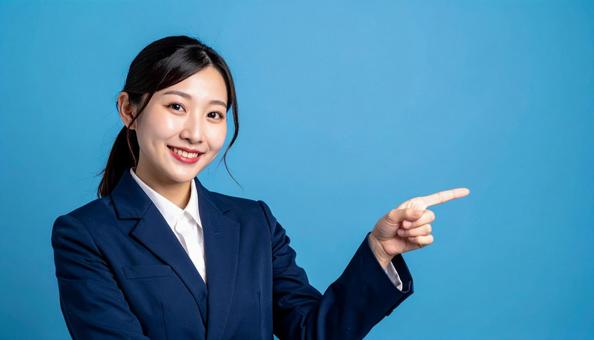 笑顔で指差すビジネスウーマンの写真