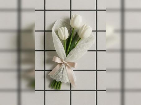 白いタイルに映える白いチューリップの花束 白いタイルに映える白いチューリップの花束の写真