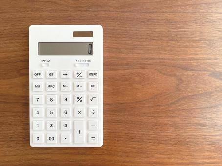 White calculator on a wooden table, JPG White calculator on a wooden table, JPG